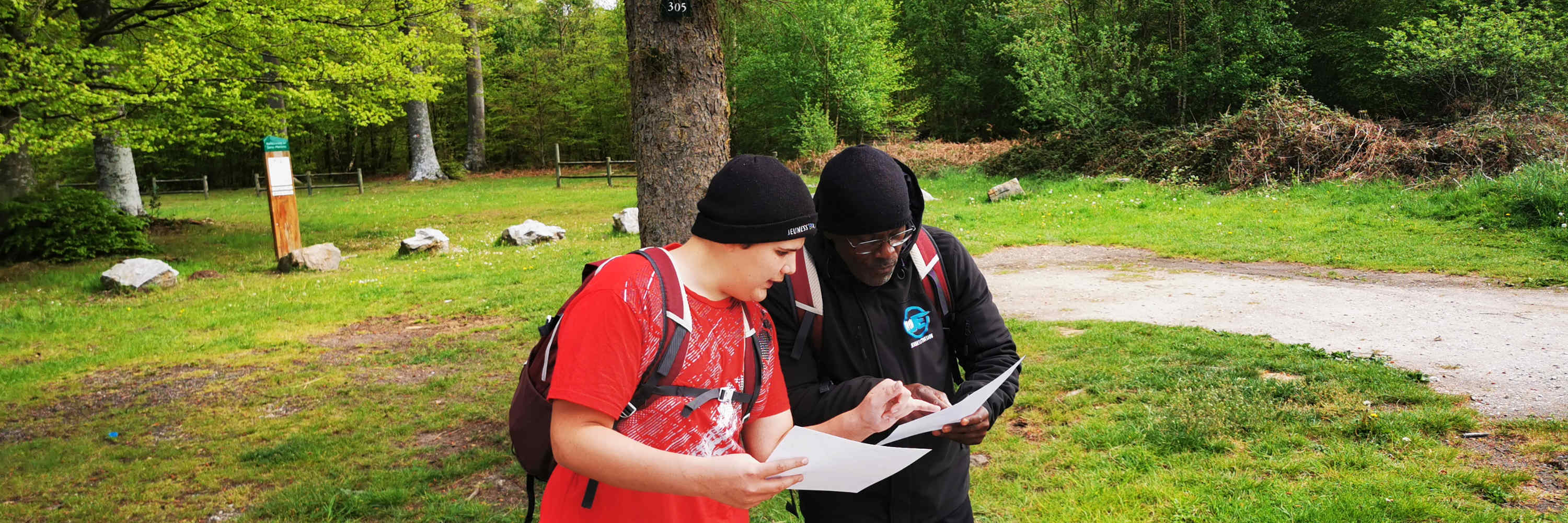&Eacute;quipe en rallye nature lisant une carte en for&ecirc;t